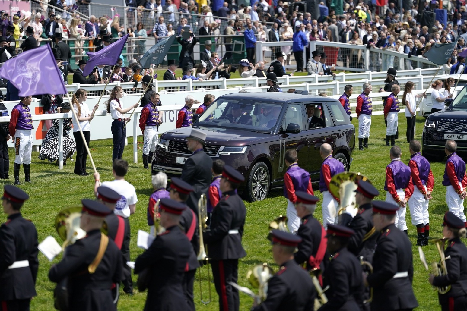 Spectacular sight at Epsom as Queen’s jockeys form guard of honour 